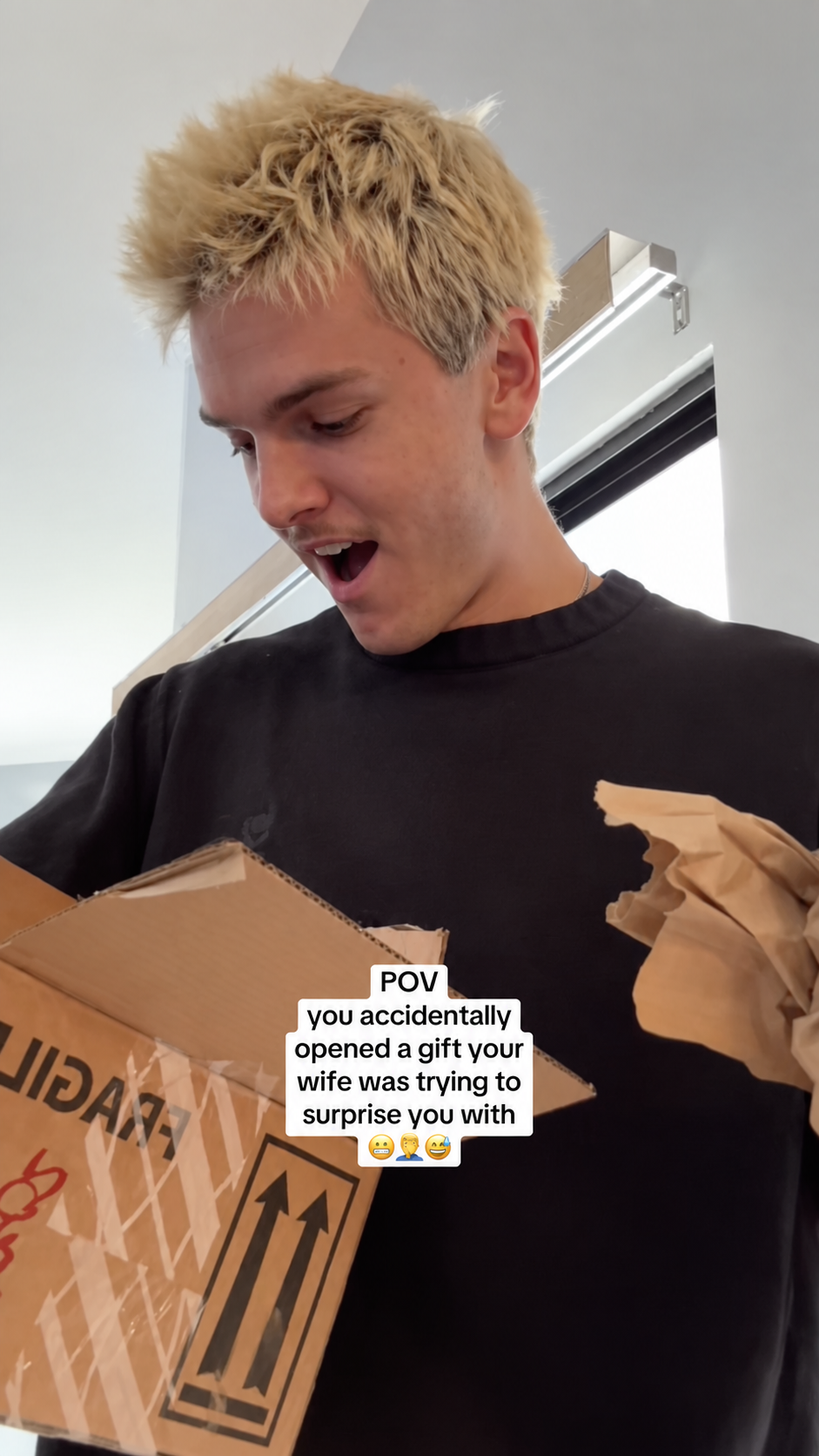 Lucas opening a box containing a handheld gaming console.